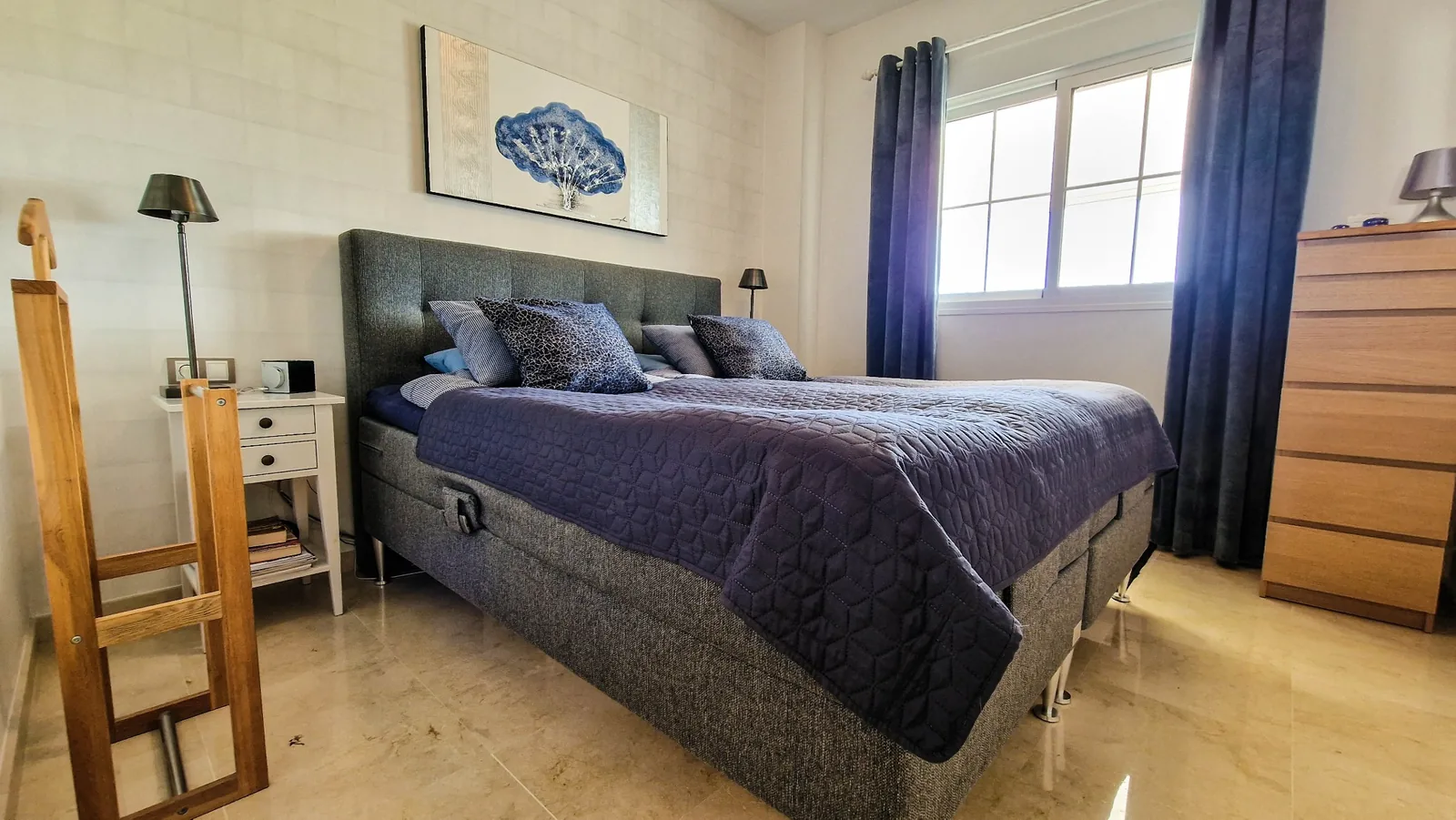 Double bedroom with window and calm neutral decor