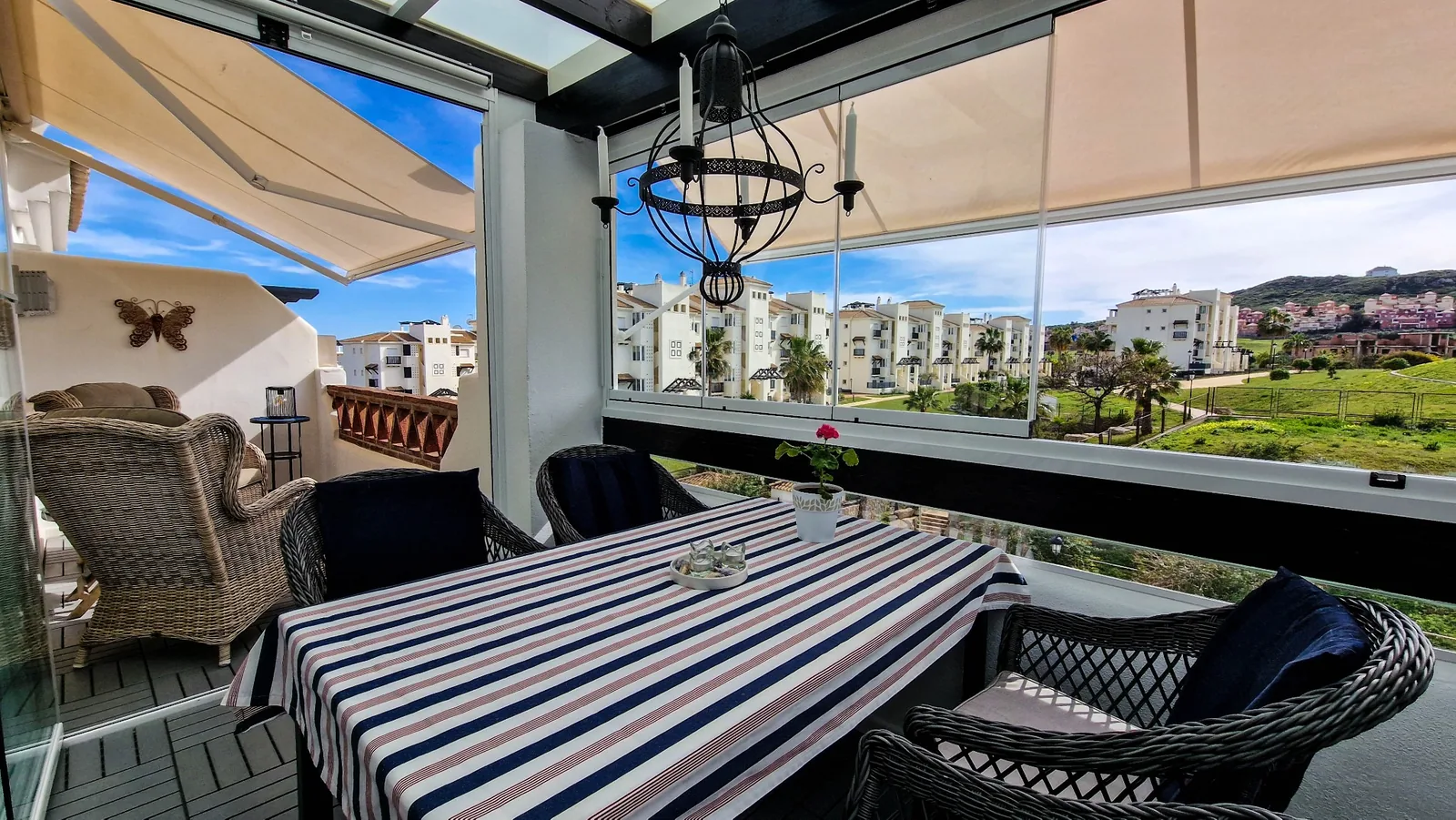 Covered terrace with dining table and views over the development